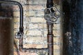 Rusty valves on boiler room pipes. Old metal boiler generating heating and delivering it to home through pipeline Royalty Free Stock Photo