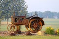 rusty vintage farm tractor display rural farm bright flowers Royalty Free Stock Photo