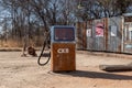 Rusty vintage petrol pump among other old memorabilia