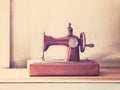 Rusty vintage sewing machine on wooden table Royalty Free Stock Photo