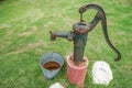 Rusty vintage water pump with stainless bucket