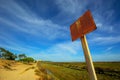 A rusty warning sign in Formosa natural reserve area, Algarve