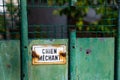 Rusty warning sign written in French saying `Nasty dog`