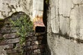 Rusty Water Down Spout on an Eroding Exterior Wall