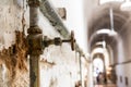 Rusty water pipes of old prison. Royalty Free Stock Photo