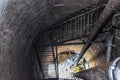 Rusty water tower inside view from top to bottom. Old water pump. Ladder to water tank, pigeon droppings Royalty Free Stock Photo