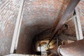 Rusty water tower inside view from top to bottom. Old water pump. Ladder to water tank, pigeon droppings Royalty Free Stock Photo