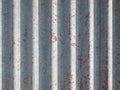 A rusty and weathered looking piece of corrugated metal. Old steel background. Metal sheet texture. Old galvanized iron backdrop. Royalty Free Stock Photo