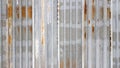 A rusty and weathered piece of corrugated metal. Corroded galvanized iron sheet. old zinc wall background Royalty Free Stock Photo