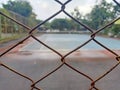 Rusty wire fences and empty tennis courts.