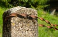 Rusty Wire on Weathered Stone Post Royalty Free Stock Photo