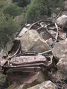 Rusty Wrecked Car in Arizona Desert with Rock on Top