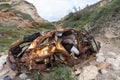 A rusty wrecked car on the beach