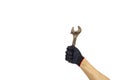 Rusty wrench, man`s hand holding spanner, isolated. Rusty adjustable wrench in gloved hand Royalty Free Stock Photo