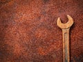 Rusty wrench tool on old metal background Royalty Free Stock Photo