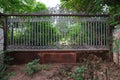 Rusty wrought iron gate between stone columns