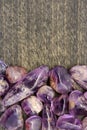 Rutilated amethyst jewel heap on black wood half background. Place for text