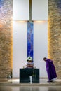 Priest and coffin at mourning ceremony