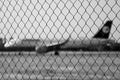 Ruzyne, Czech republic - August 16, 2018: iron fence with Lufthansa aeroplane on background in Vaclav Havel airport in Prague duri