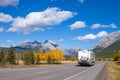 An RV aon the highway through the Canadian Rocky Mountains in Kananaskis, Alberta during the peak of autumn colors Royalty Free Stock Photo