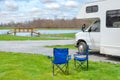 RV camper and chairs in camping, family vacation travel, holiday trip motorhome Royalty Free Stock Photo