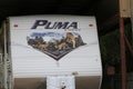 An RV or Camper shot closeup with the decal on the front with the Puma brand and Logos on a summer day in Kansas.