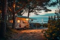 RV motorhome camping spot by the beach at dusk with string lights and tranquil sea view Royalty Free Stock Photo