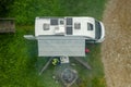 RV Park Pitch with Camper Van and Campfire Place Aerial View