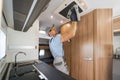 RV Rental Company Worker Cleaning Motorhome Air Condition Unit Royalty Free Stock Photo