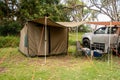 RV tent with attached awning setup at the campsite surrounding by nature in caravan holiday park. Camping life concept. Instant