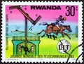 RWANDA - CIRCA 1977: A stamp printed in Rwanda shows Chappe`s semaphore and post rider, circa 1977.