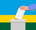 Rwanda election concept. Hand puts vote bulletin Royalty Free Stock Photo
