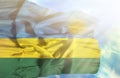 Rwanda waving flag against blue sky with sunrays