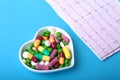 RX prescription and colorful assortment pills and capsules on plate.