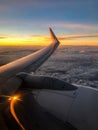 Ryanair airplane flight above the clouds at sunset