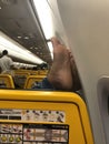 04/11/2019 - Ryanair flight from Warsaw in Poland to Amman in Jordan - Passenger resting his feet on the wall inside the aeroplane Royalty Free Stock Photo