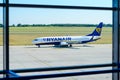 Ryanair plane seen through the window of Airport in Poznan