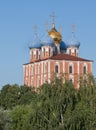 Ryazan, Russia. The Cathedral of the Dormition Uspensky Cathedral in the Kremlin in the greenery on the background blue sky