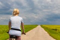 Ryazan, Russia - July 18, 2023: girl riding a bike on a country road