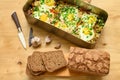 Rye bread, baked mixed vegetables and eggs close view, baking tray with tomatoes, broccoli and spices, home cooking Royalty Free Stock Photo