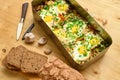 Rye bread, baked mixed vegetables and eggs close view, baking tray with tomatoes, broccoli and spices, home cooking Royalty Free Stock Photo