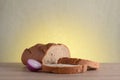 Rye bread, basil and red bulb onion on a wooden table.