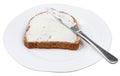 Rye bread with Cheese spread and knife on plate Royalty Free Stock Photo