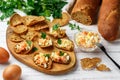 Rye bread chips with salad of salted or smoked fish