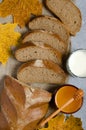 Rye bread is cut into pieces. Honey, milk in a glass Cup, yellow maple leaves. Traditional rural food. Vertical photo