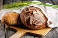 Rye bread with grains on wooden breadboard, food background, freshly baked traditional bread