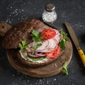 Rye bread sandwich with ham on a dark background. Royalty Free Stock Photo