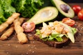 Rye bread sandwich with shrimp, avocado, tomatoes and breadsticks