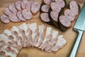 Rye bread sandwiches with smoked sausage and sliced bacon on wooden board. Royalty Free Stock Photo