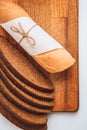Rye bread slices and Fresh Homemade Sliced French Baguette Bread on the wooden board in the white background Royalty Free Stock Photo